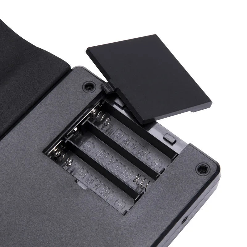 Portable folding electronic keyboard with 49 silicone rubber keys in hand roll design, shown in gloss black finish