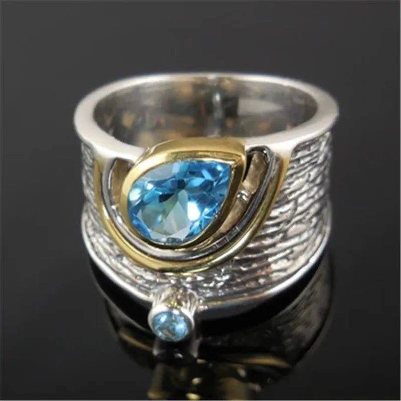Chinese style blue zircon rhinestone alloy ring in a drop shape on a model's finger.