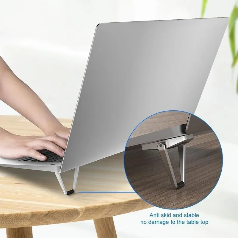 Small silver aluminium foldable computer bracket with 3M adhesive strips for laptop mounting