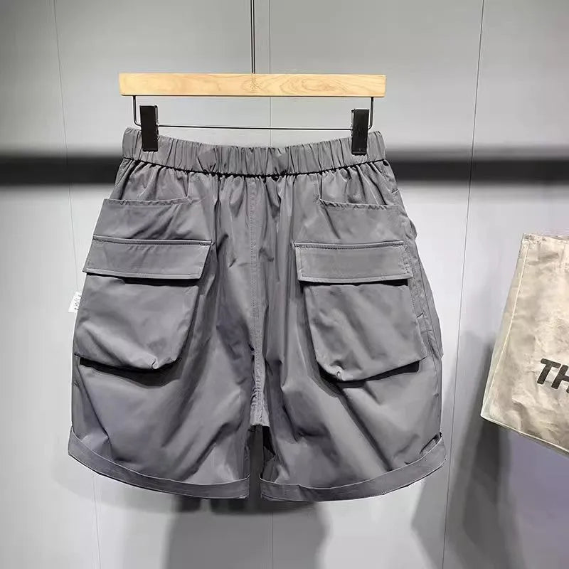 Men's black loose fit work shorts with pockets and straight leg hem above knee length
