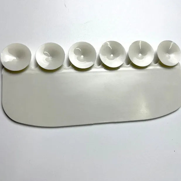 White PVC urine blocking splash guard for toilet training, shown on a toilet seat.