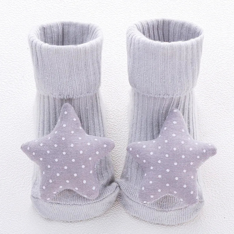 Cotton baby floor socks with non-slip soles in a pink bow print design.