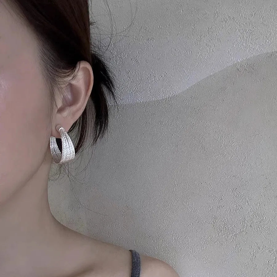 Simple geometric bracelet earrings with clip and stud backs in silver or gold colour.