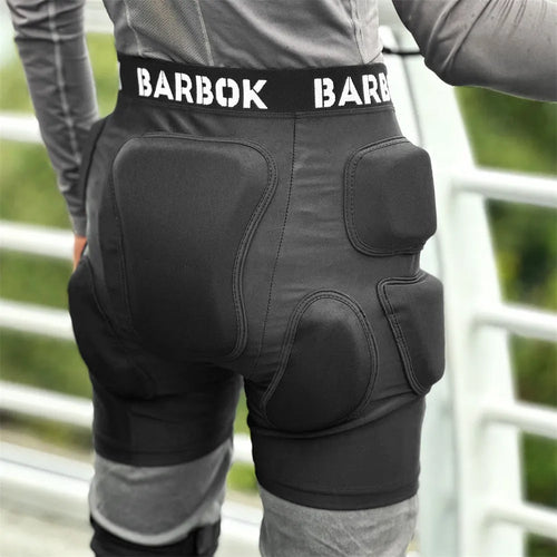 Black adult hip protection shorts with removable padding for skating and skiing safety.