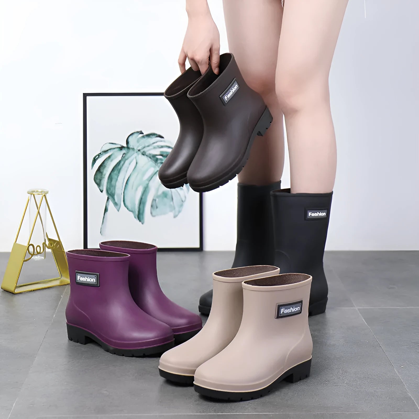 Women's mid-calf rain boot in PVC, low heel, shown in black colour.