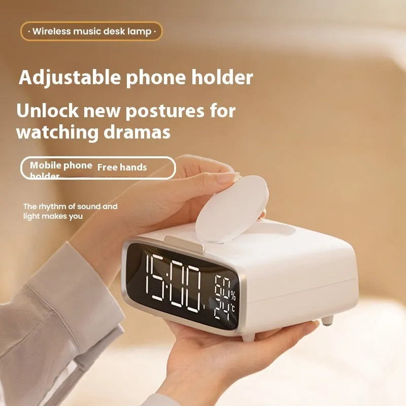 White wireless charger Bluetooth speaker with night light on desk beside smartphone