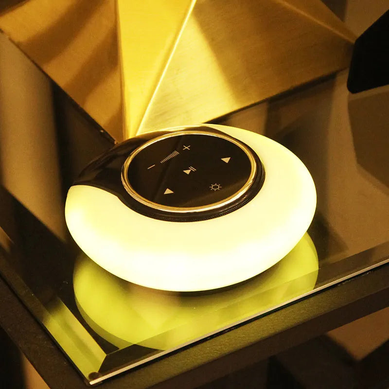 Square blue Bluetooth speaker lamp with touch controls, showing white LED light and folding design.