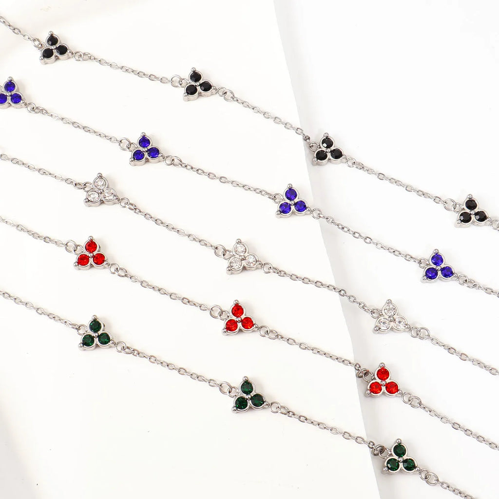 Geometric stainless steel women's bracelet with triangular links and a coloured stone centre.