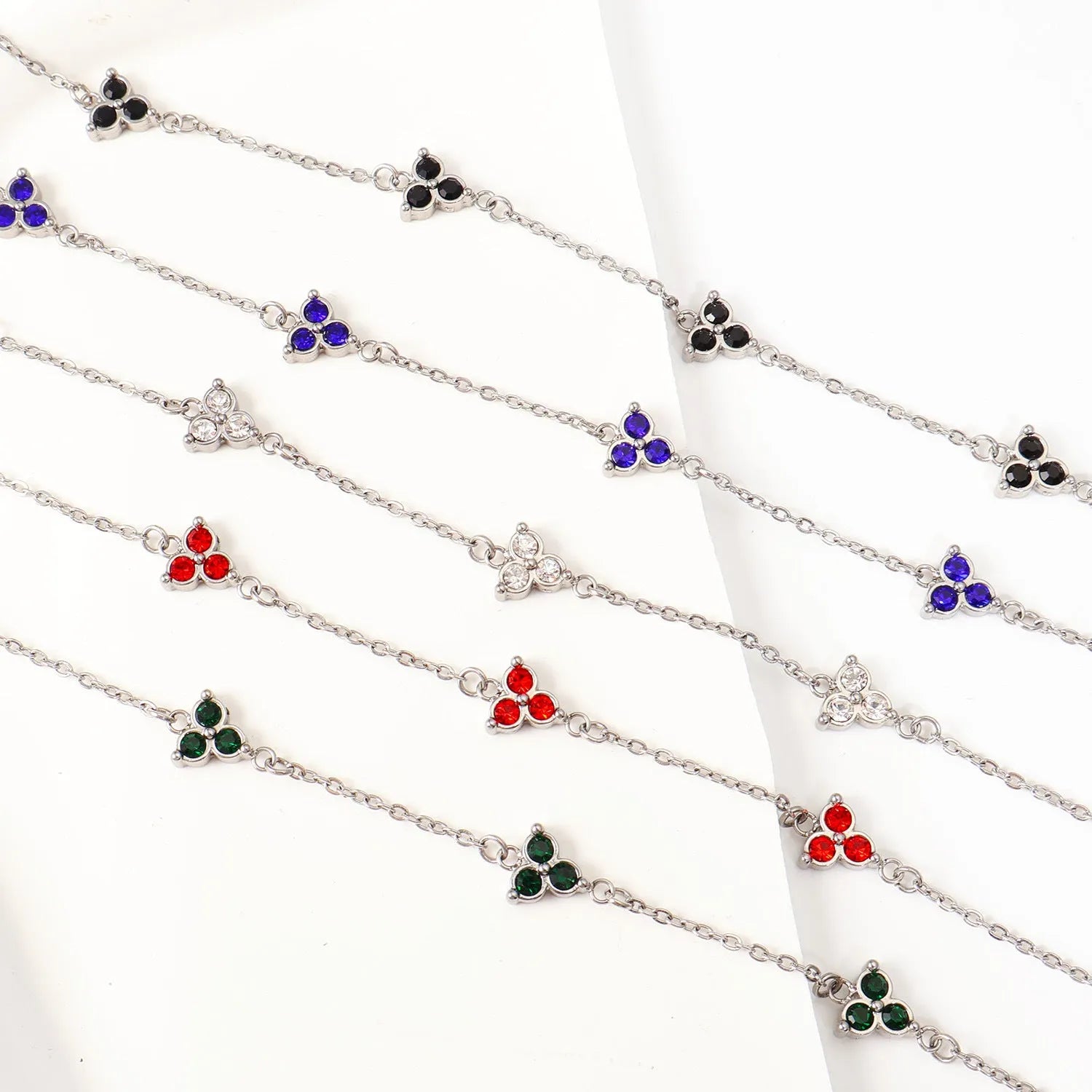 Geometric stainless steel women's bracelet with triangular links and a coloured stone centre.