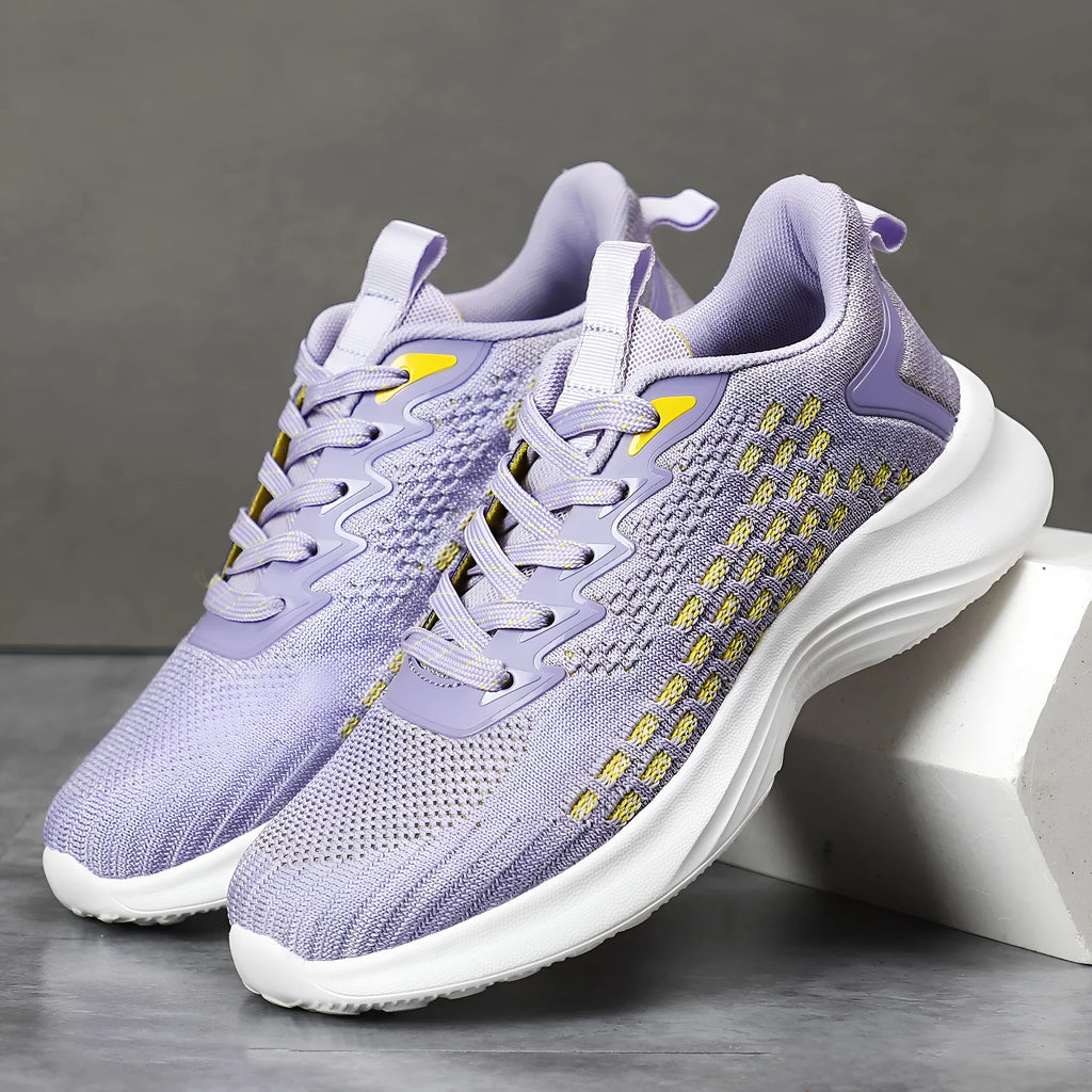 Women's lavender purple Flyknit mesh running shoes with round toe and flat wedge heel on a white background.