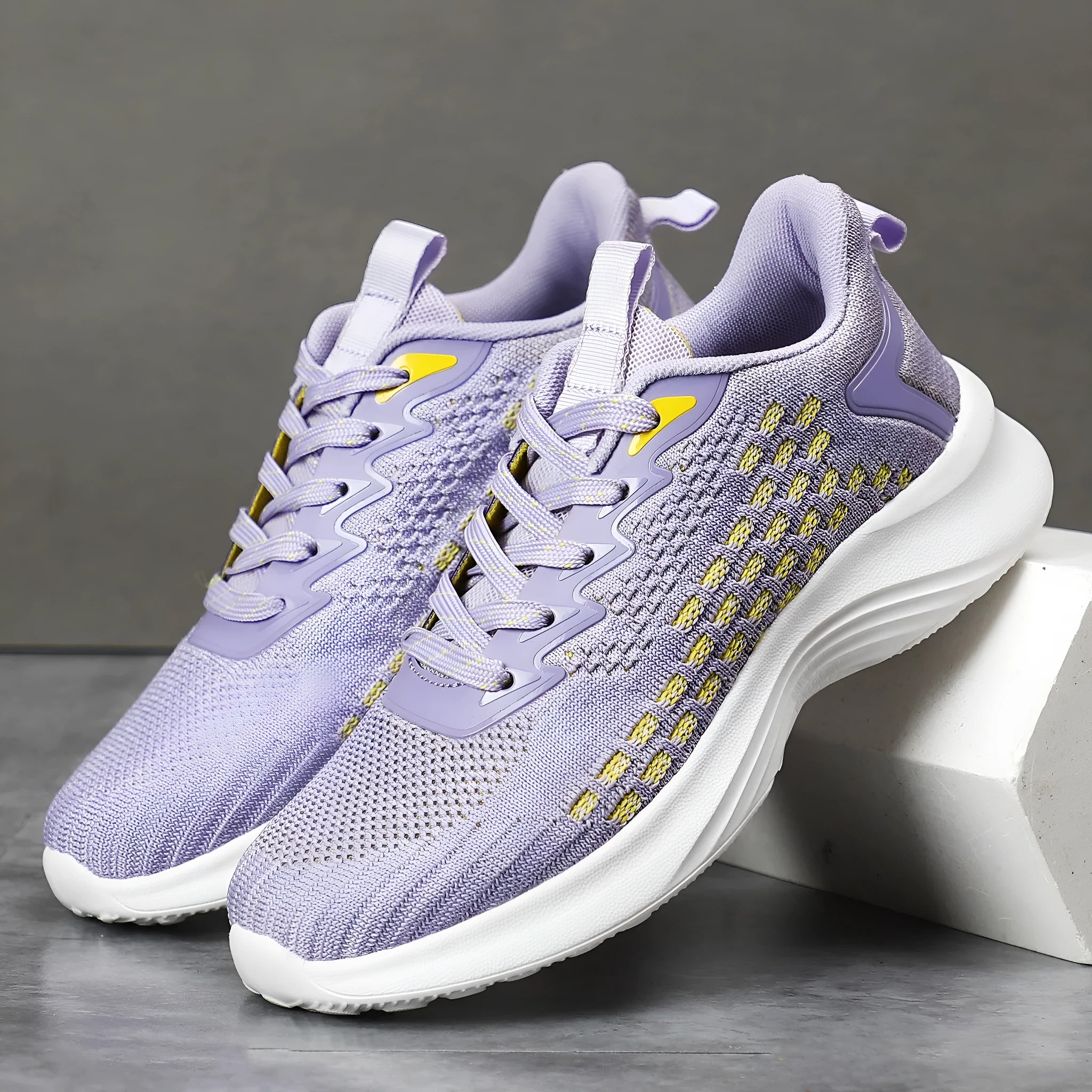 Women's lavender purple Flyknit mesh running shoes with round toe and flat wedge heel on a white background.