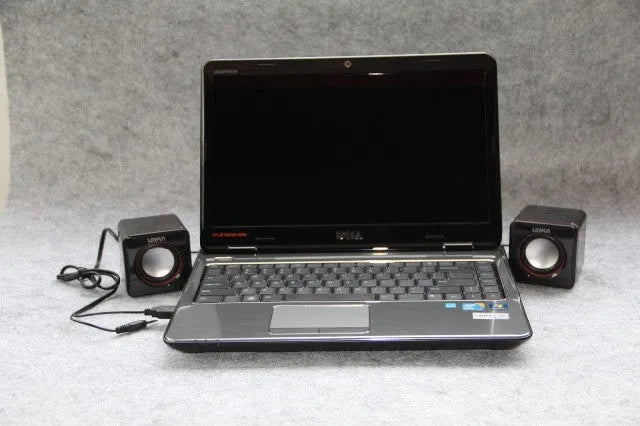 Small black square computer speaker with USB cable for desktop audio
