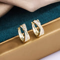 Geometric drop earrings with zircon detailing in 14K yellow gold-coloured copper