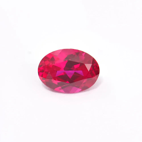 A loose, faceted artificial ruby gemstone in a deep pigeon blood red colour.