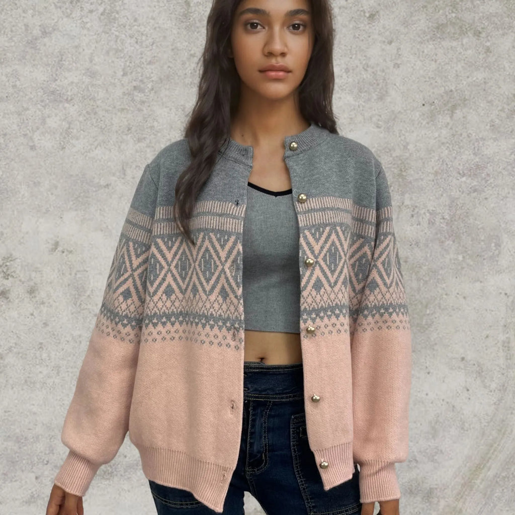 Woman wearing a red alpaca wool cardigan with a diamond knit pattern and long sleeves.