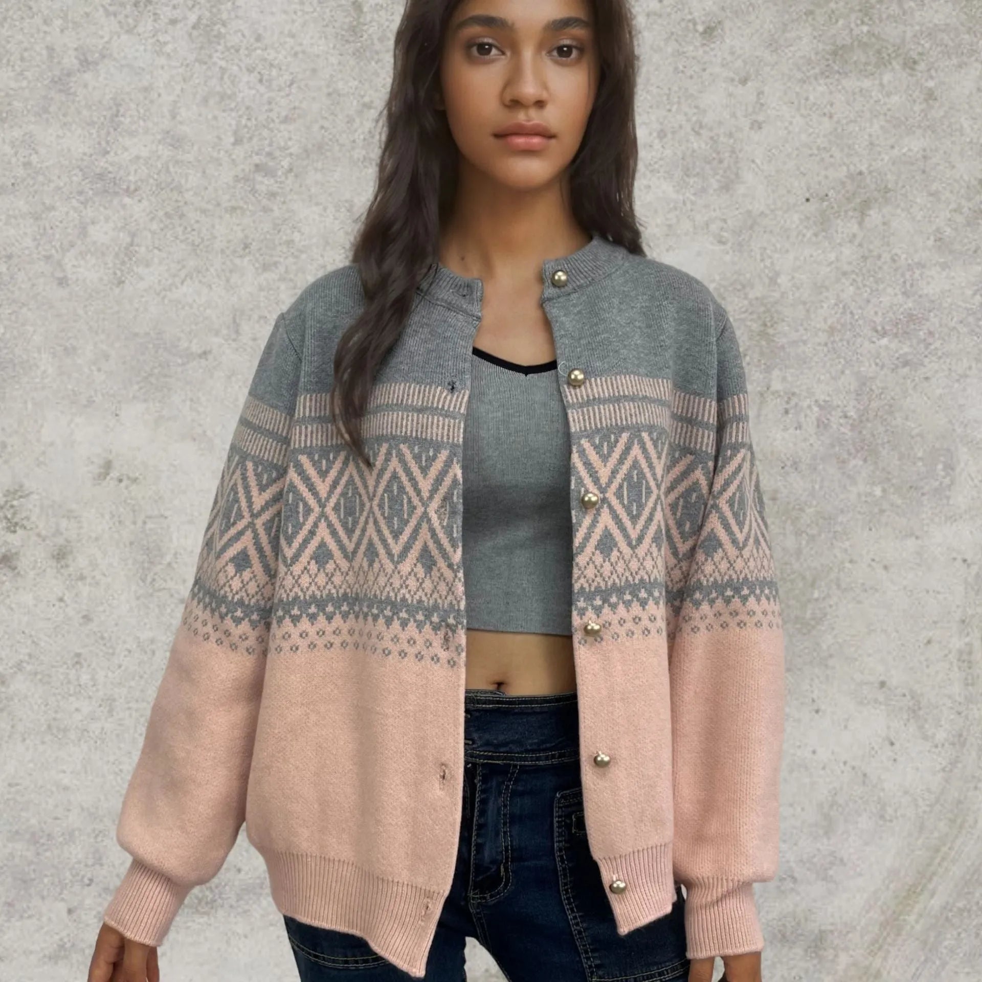 Woman wearing a red alpaca wool cardigan with a diamond knit pattern and long sleeves.