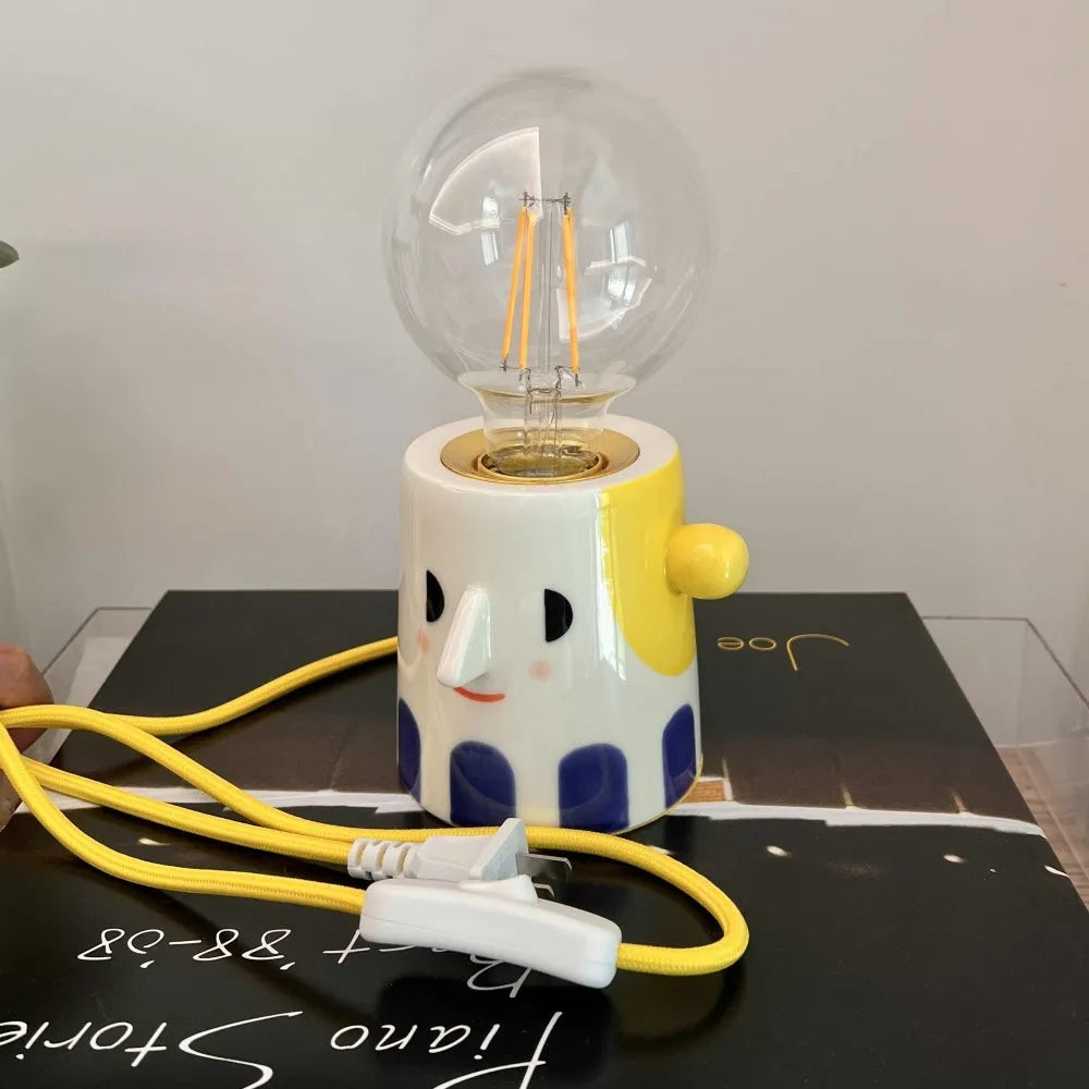 Handmade ceramic bedside lamp with ball headlight shade on wooden surface