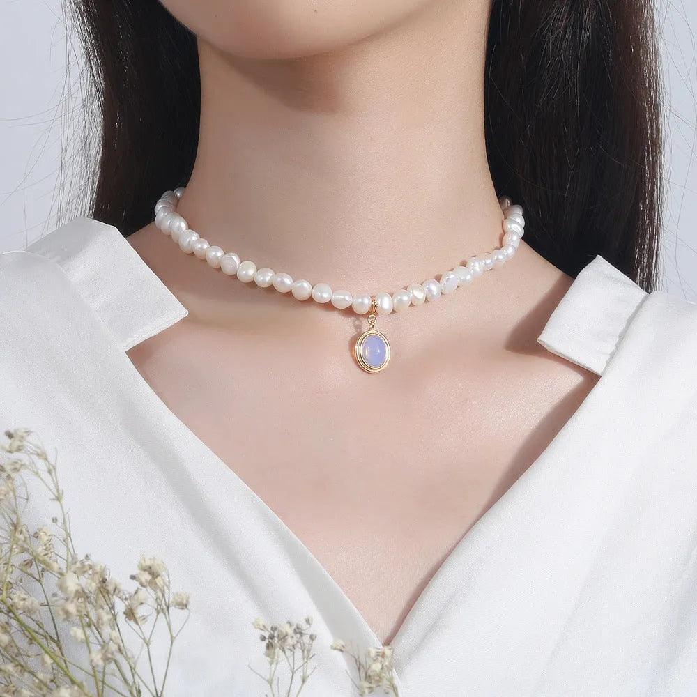 Silver necklace with round medal pendant and irregular freshwater pearls on adjustable chain