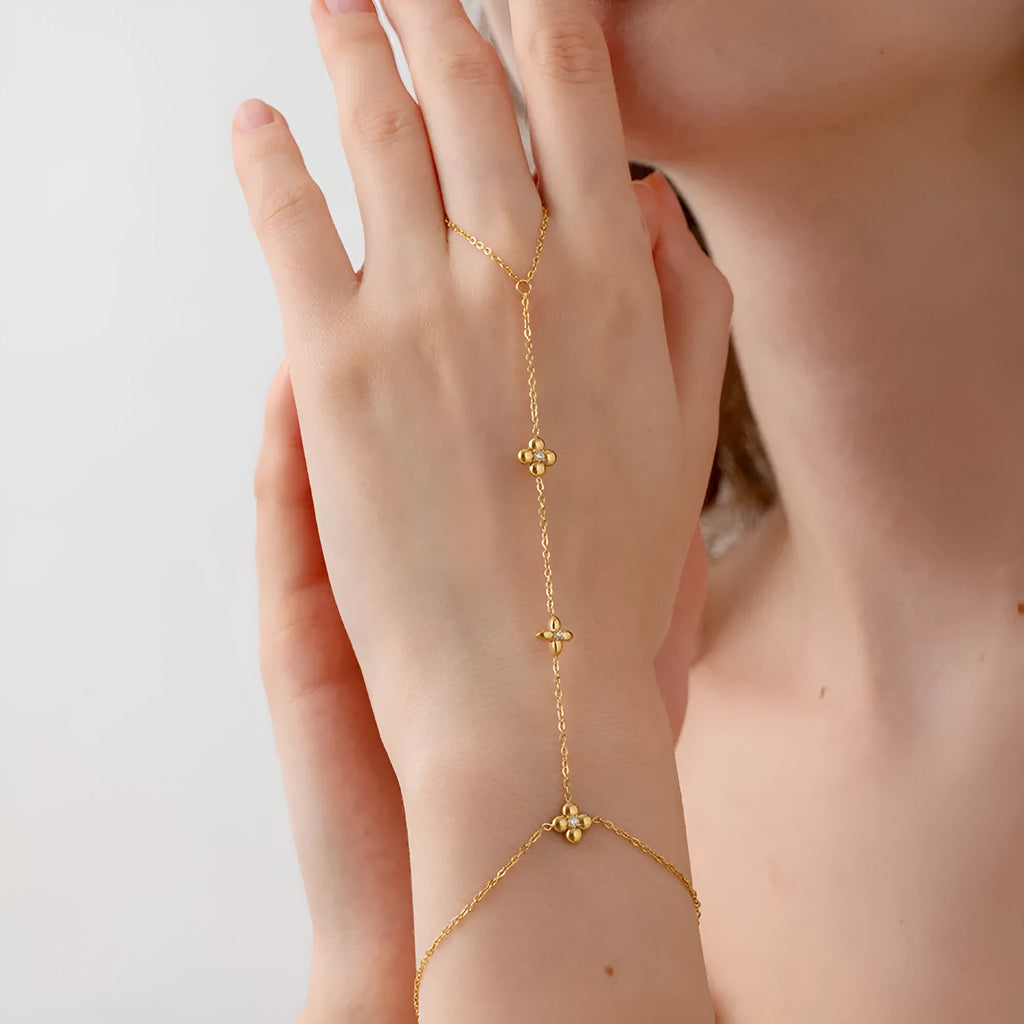 Gold colour women's bracelet with geometric eight-pointed stars and floral design elements on stainless steel