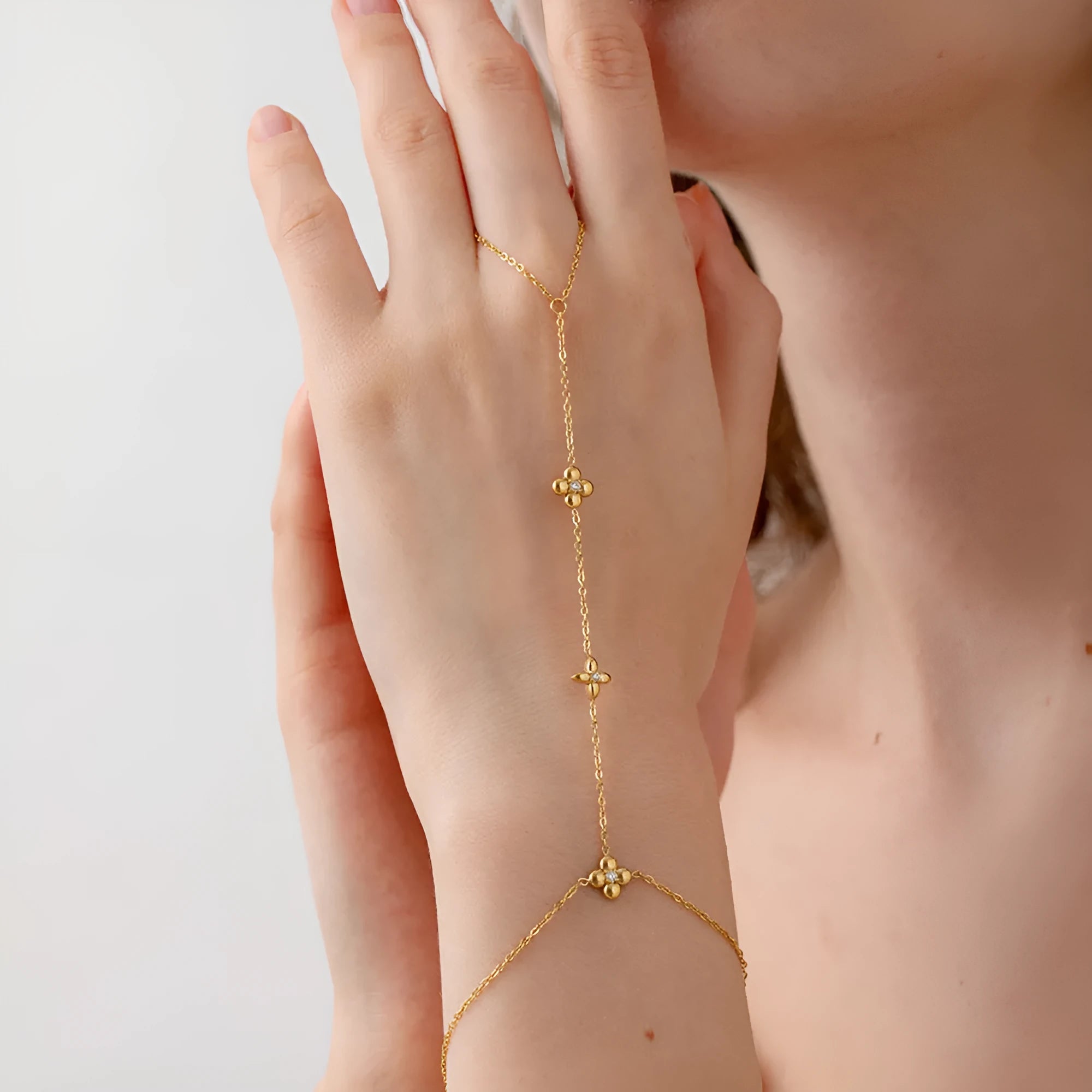 Gold colour women's bracelet with geometric eight-pointed stars and floral design elements on stainless steel