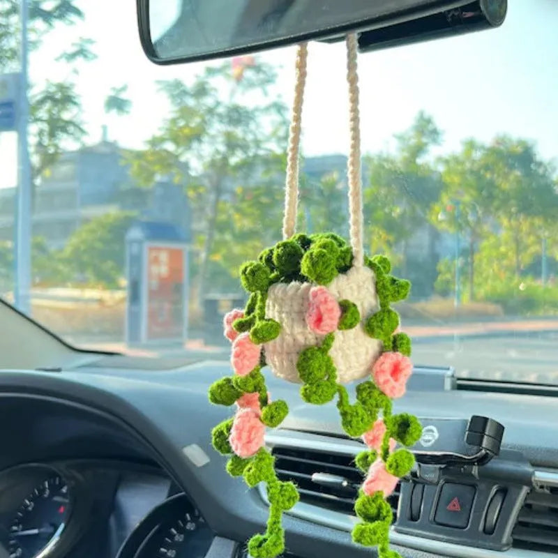 Green and white fish-scale style knitted wool car hanging planter with 8cm base and long white cord.