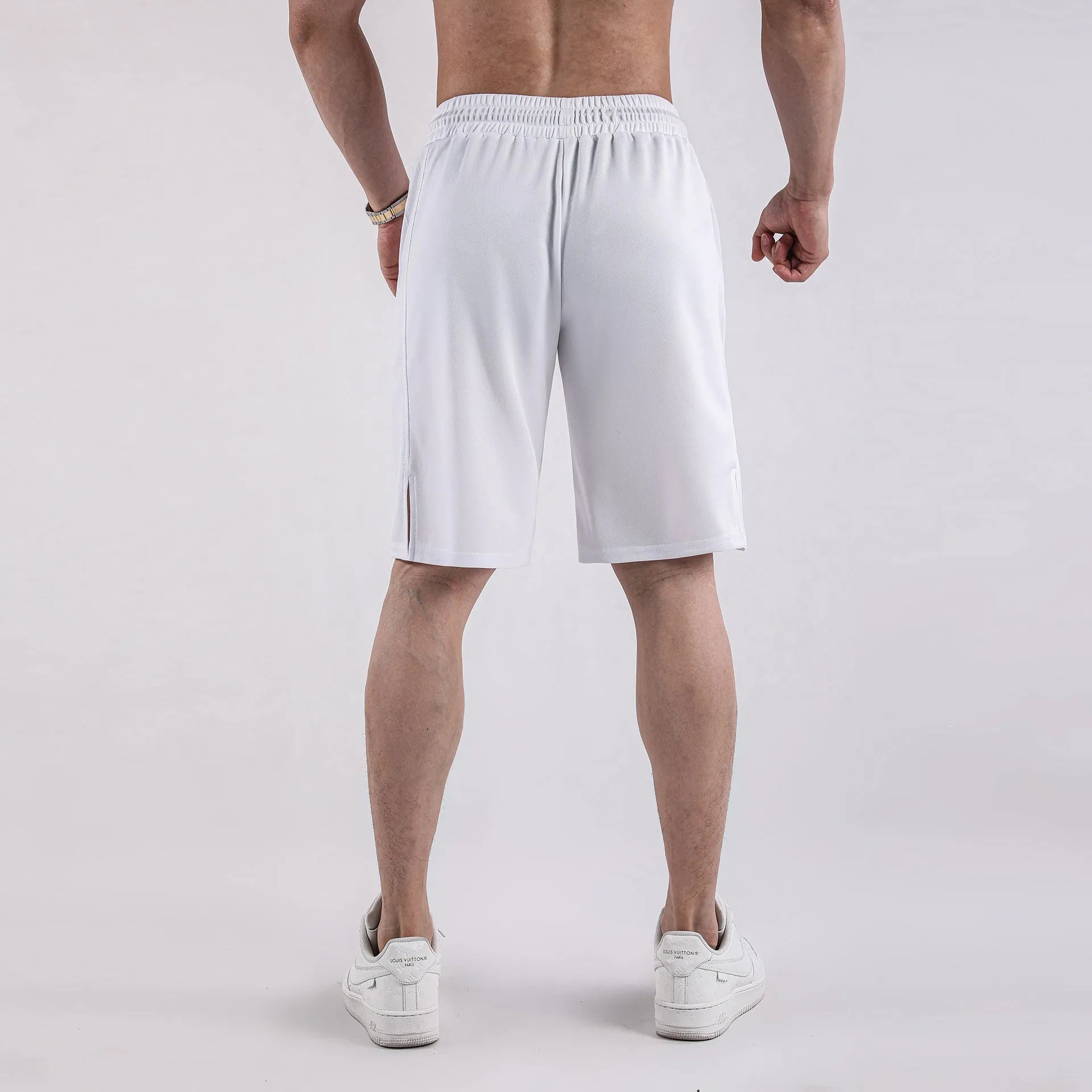 Man wearing loose black quick-drying capri pants for casual summer wear.