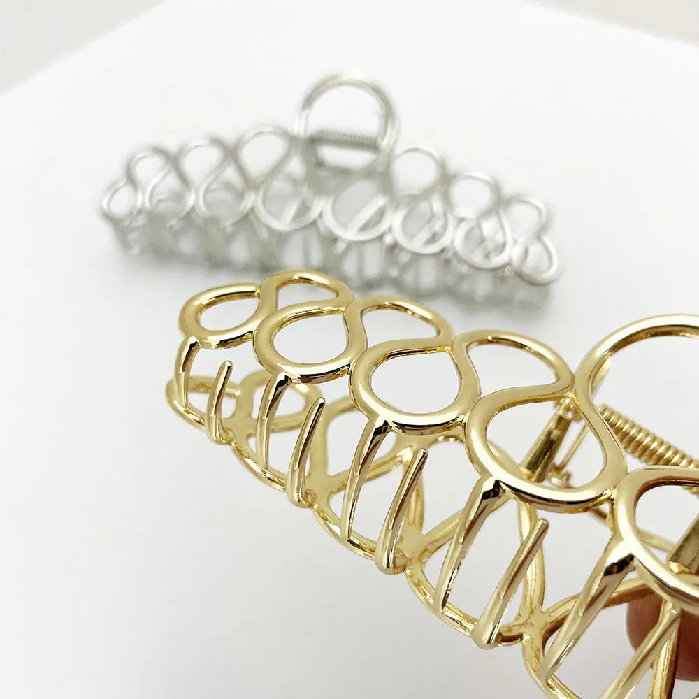 Minimalist large hair clip with tassel detailing in gold or silver metallic finish for updo hairstyles
