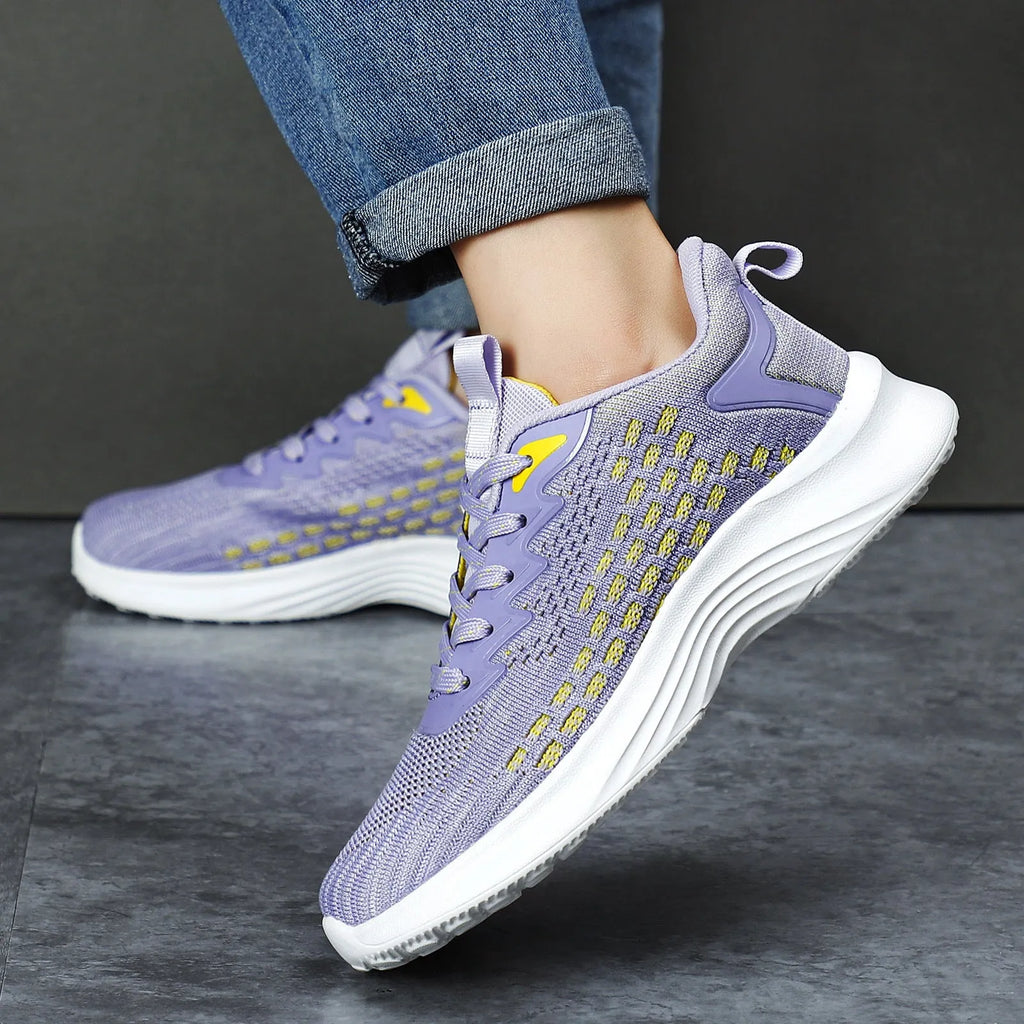 Women's lavender purple Flyknit mesh running shoes with round toe and flat wedge heel on a white background.