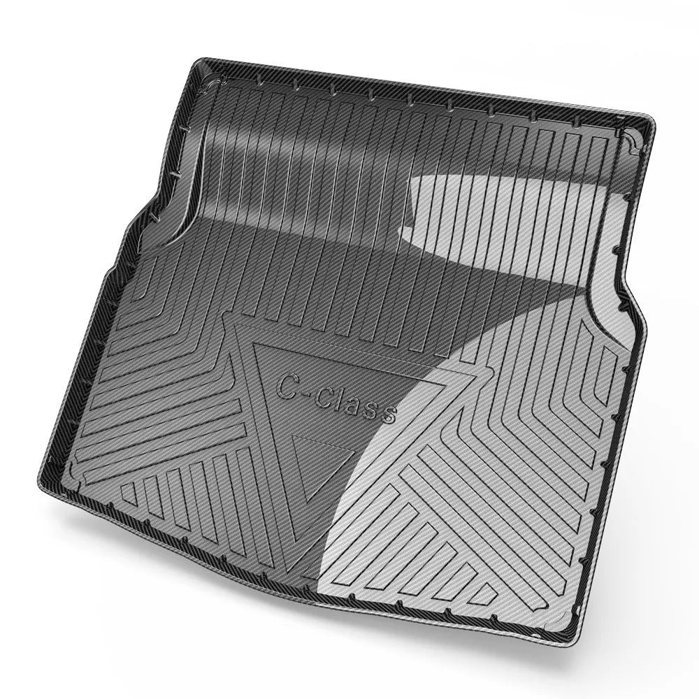 Black carbon fibre pattern TPE car trunk protector mat lying flat.