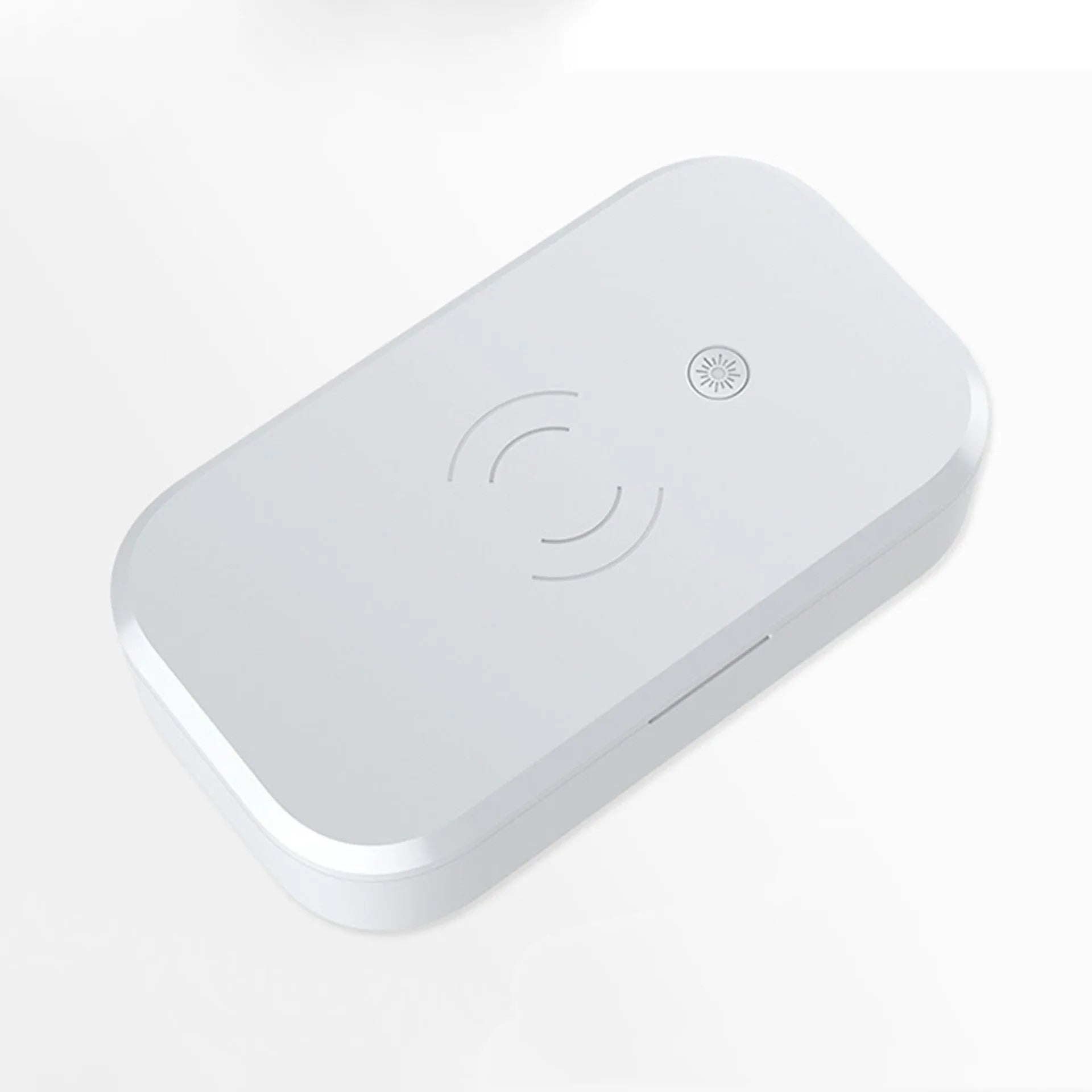 White multifunctional UV disinfection box with wireless charging pad for mobile phones and nail tools.