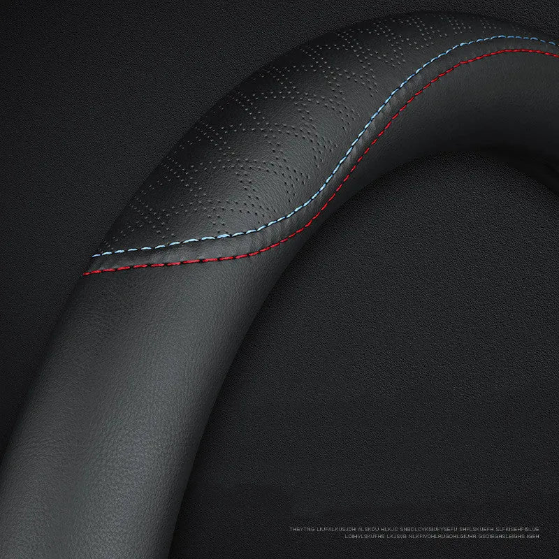 Black leather steering wheel cover with two-colour line detailing showing Napa leather texture and rubber inner ring