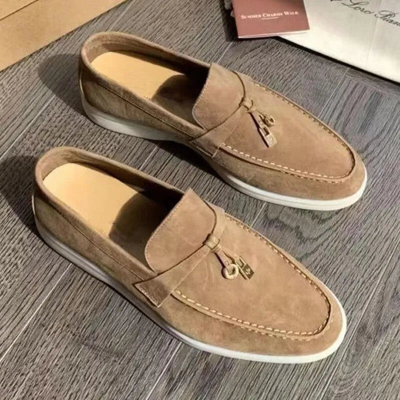 Unisex black slip-on casual loafers with rubber sole and round toe cap on a white background