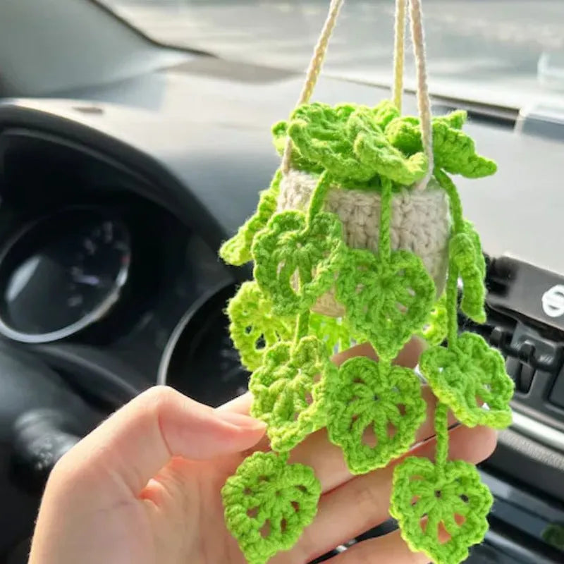 Green and white fish-scale style knitted wool car hanging planter with 8cm base and long white cord.