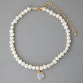 Silver necklace with round medal pendant and irregular freshwater pearls on adjustable chain