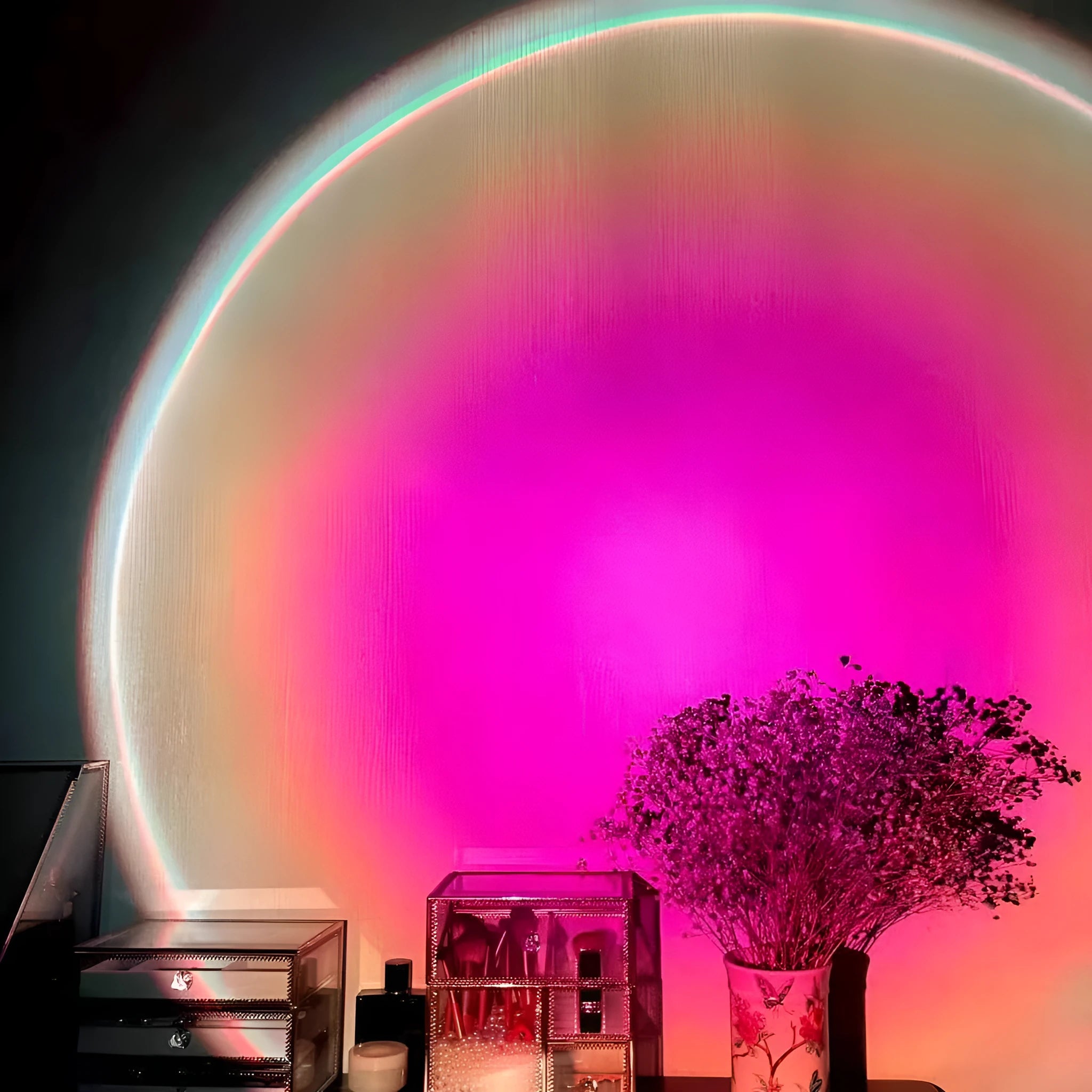 Rechargeable sunset projection lamp showing rainbow colour patterns with USB power cable