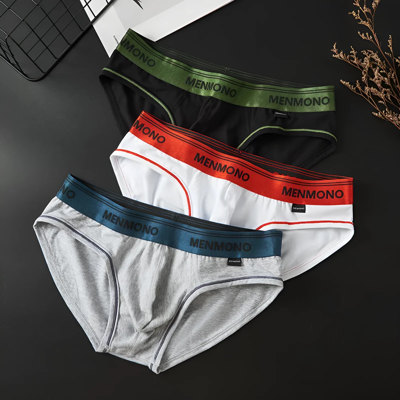 Men's low waist cotton briefs showing two-tone colour combinations including black/blue and white/red options