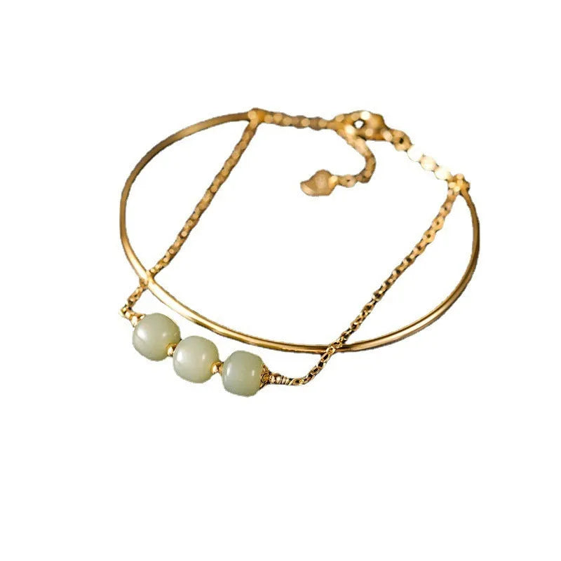 Women's jade lucky beads bracelet with gold inlay in single, double, and three bead versions.