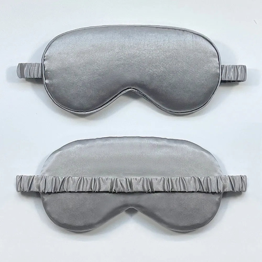 Double-sided silk-like sleep mask in rayon satin, shown in multiple colour options on a white background.