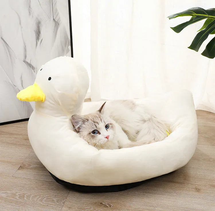 Blue duck-shaped fluffy pet bed sofa for small dogs and cats on a floor.