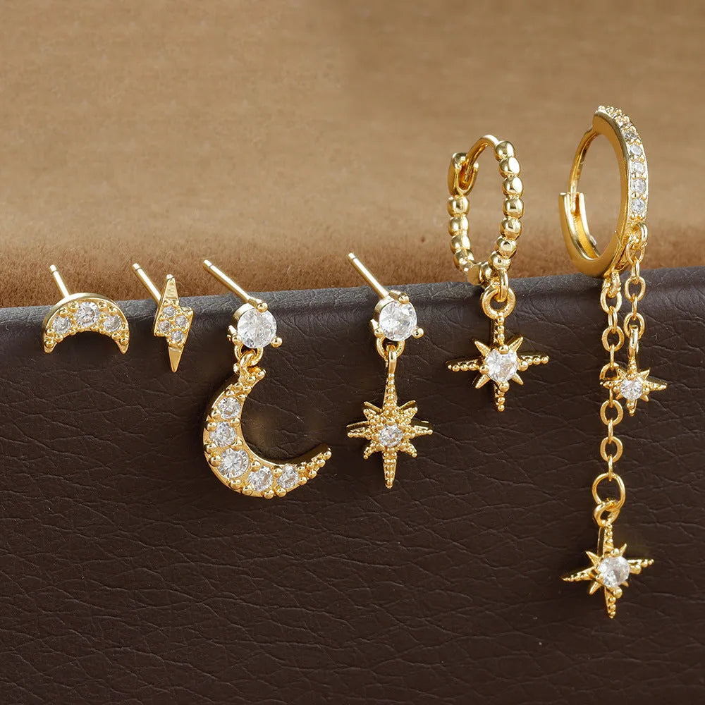 XINGX gold chain tassel earrings set with zircon stud accents, six individual pieces shown