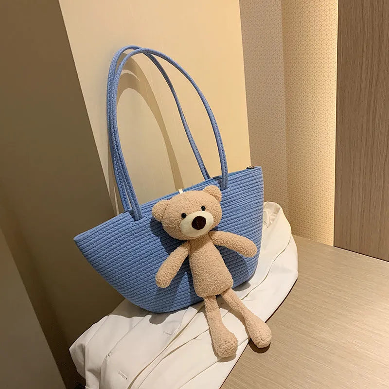 Woven cotton linen shoulder bag in dumpling shape with double straps and three-dimensional pocket.