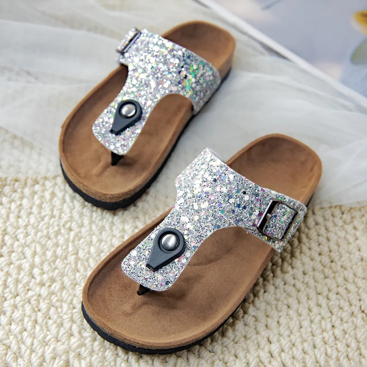 Gold cork flip-flops with a frosted artificial leather upper and a textured PVC sole.