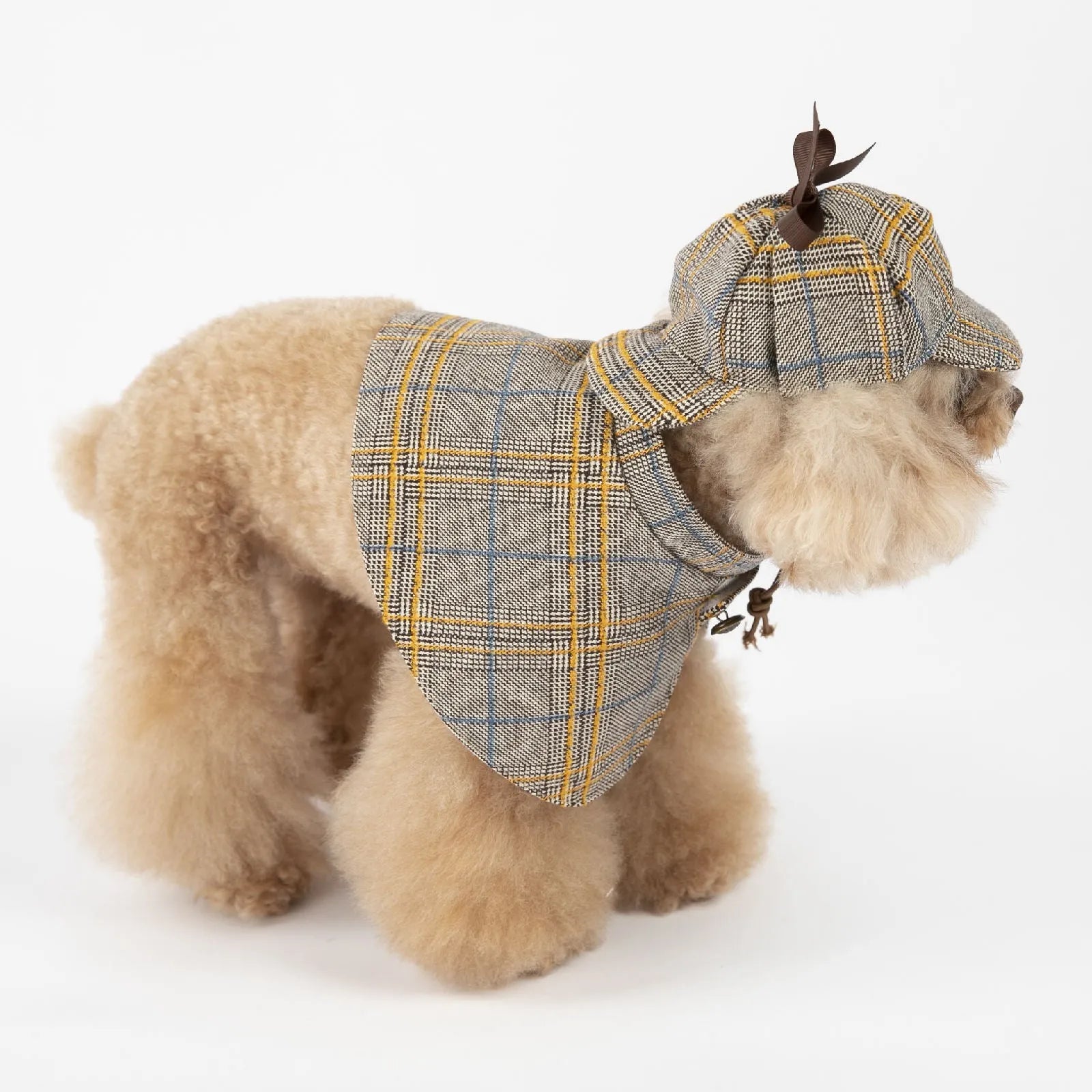 Camel coloured cotton detective cloak for dogs on a hanger, showing the adjustable hat.