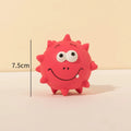 Four colourful squeaky dog balls with textured surfaces and cute faces