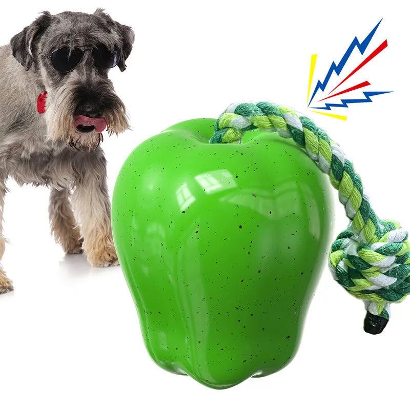 Green and red apple-shaped plastic dog toy with hollow centre for treat dispensing