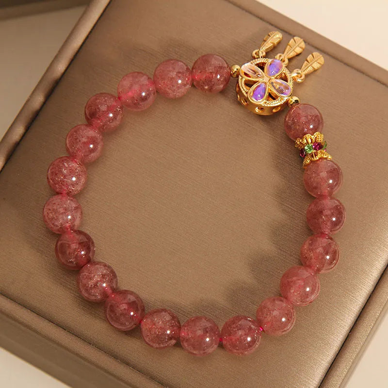 Women's strawberry quartz bracelet with four-leaf dream catcher pendant on crystal beads