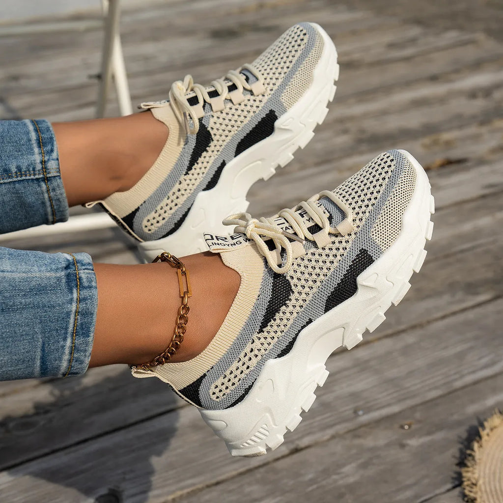 Women's Flyknit mesh lace-up sneakers in multiple colours with low flat rubber sole.