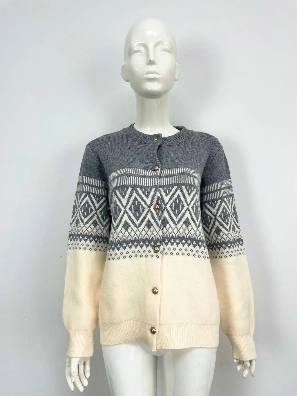 Woman wearing a red alpaca wool cardigan with a diamond knit pattern and long sleeves.