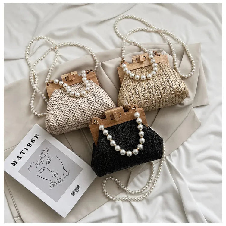 Women's straw woven shoulder bag with pearl chain detail in horizontal square shape