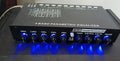 Black car audio equaliser amplifier unit with control knobs for 6-channel output and subwoofer tuning.